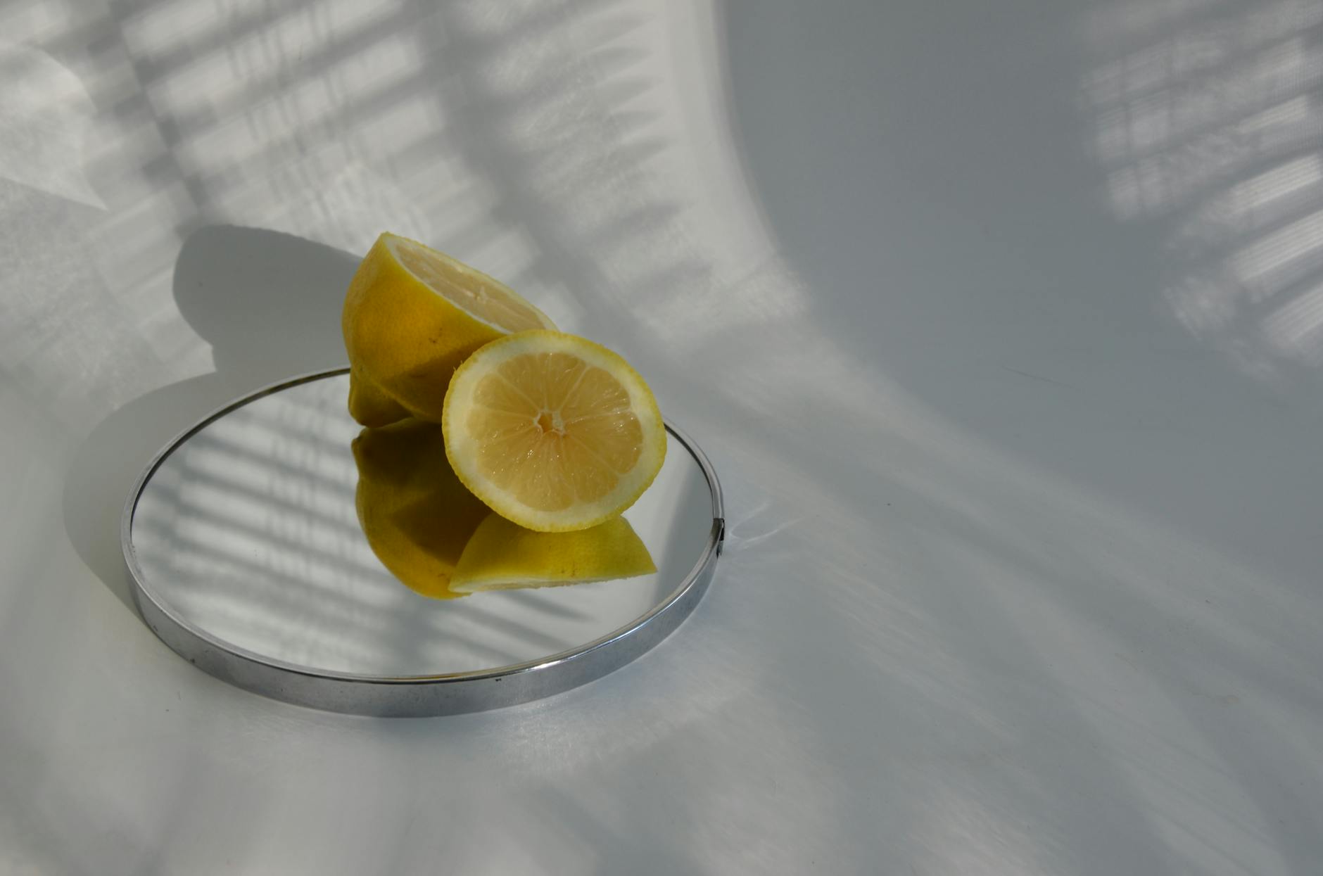 Fresh lemons arranged with books on white fabric, representing renewed energy and desire