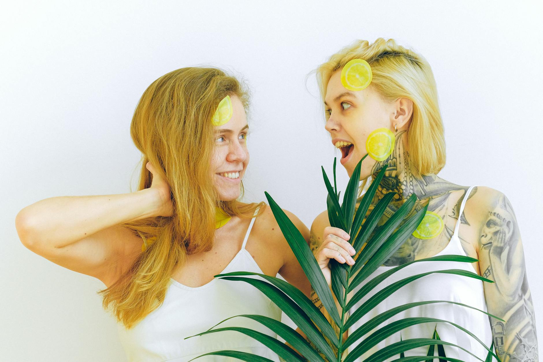 Woman holding clitoral vibrators in thoughtful consideration, representing sensitive pleasure exploration
