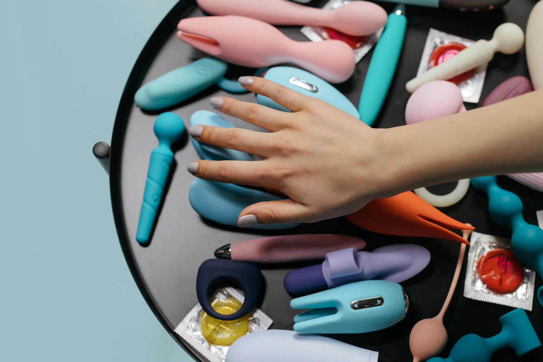 Woman holding a pink vibrator, evaluating sensations and comfort